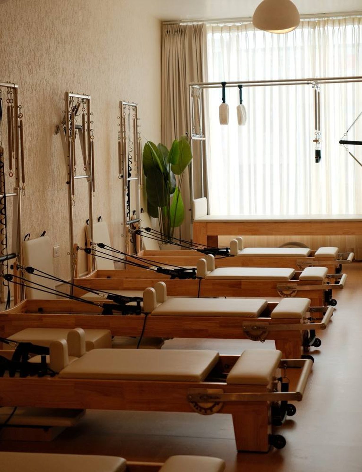 Row of Rèforme Pilates reformers installed in a professional studio